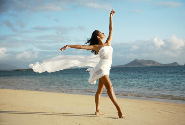 Hawaii, Oahu, Lanikai Beach, Beautiful Female Ballet Dancer On Beach Wearing White Flowing Fabric. by PacificStock
