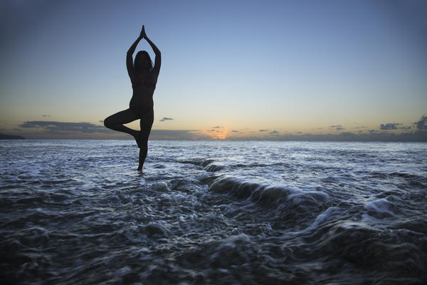 Hawaii, Oahu, Fit Young Girl On The Beach Doing Yoga On The Rocky Coastline. by PacificStock