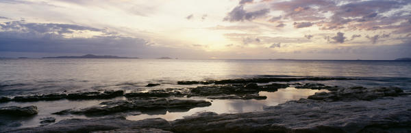 Sunrise Over Ocean And Rocky Coastline; Fiji by PacificStock