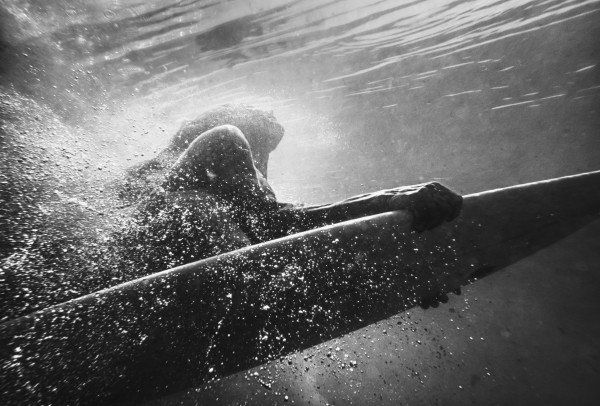 A Woman On A Surfboard Under The Water; Tarifa, Cadiz, Andalusia, Spain by PacificStock