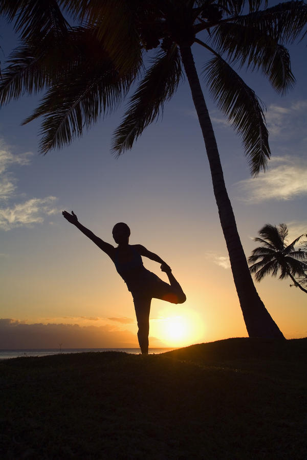 Hawaii, Maui, Olowalu, Woman Doing Yoga At Sunset Under Palm Trees. by PacificStock