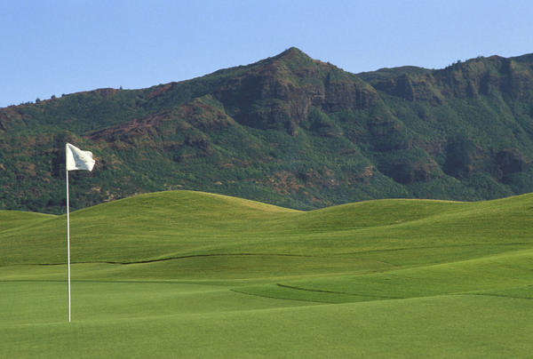 Hawaii, Kauai, Kauai Marriott Golf Course Rolling Hills With Mountains In Background, White Flag by PacificStock