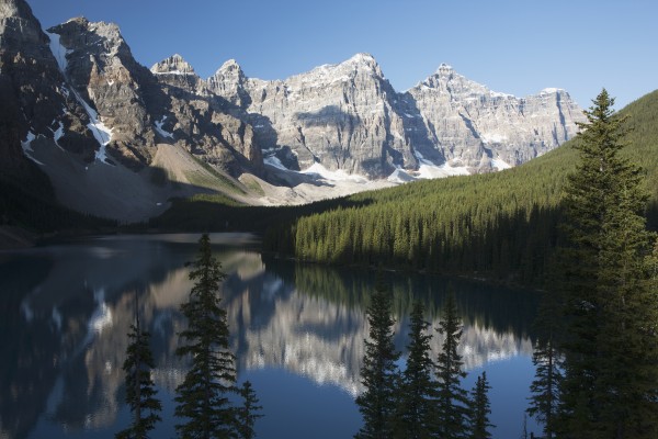 Mountain Range And Lake Reflection With Blue Sky; Alberta, Canada by PacificStock