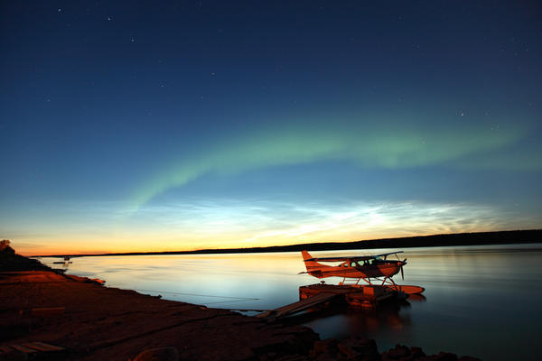 Aurora Borealis Over The Mackenzie River With Float Planes In Foreground, Fort Simpson, Northwest Territories by PacificStock