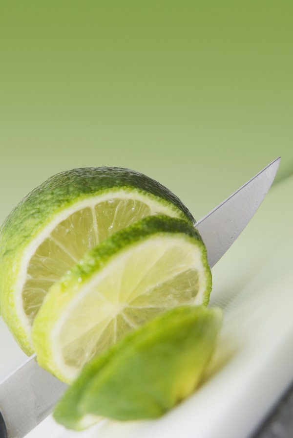 A Knife Cutting A Lime by PacificStock