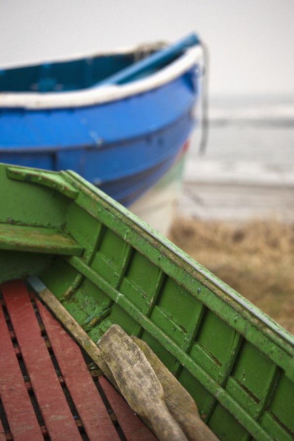 Paddles in a colourful wooden rowboat on the shore;Boulmer northumberland england by PacificStock