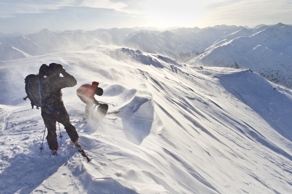 Skiers Prepare To Ski Down Peak 4940 In High Wind And Blowing Snow, Turnagain Pass, Kenai Mountains, Winter In Southcentral Alaska by PacificStock