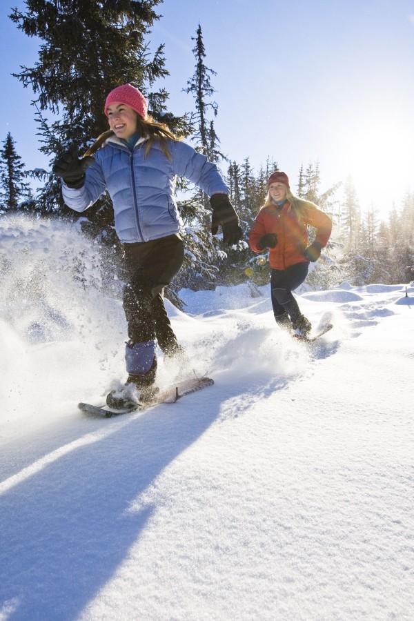 Two Young Women On Snowshoes Enjoy The Outdoors Near Homer, Alaska During Winter. by PacificStock