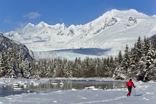 Person Cross-Country Skiing In A Winter Landscape At Mendenhall River With Mendenhall Glacier And Towers In The Background, Tongass National Forest, Southeast Alaska by PacificStock