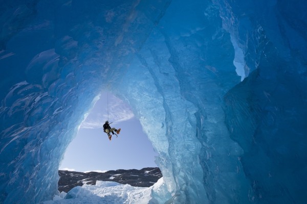 Composite: View From Inside An Ice Cave Of An Iceberg Frozen In Mendenhall Lake As An Ice Climber Rappels Down A Rope, Juneau, Southeast Alaska, Winter by PacificStock