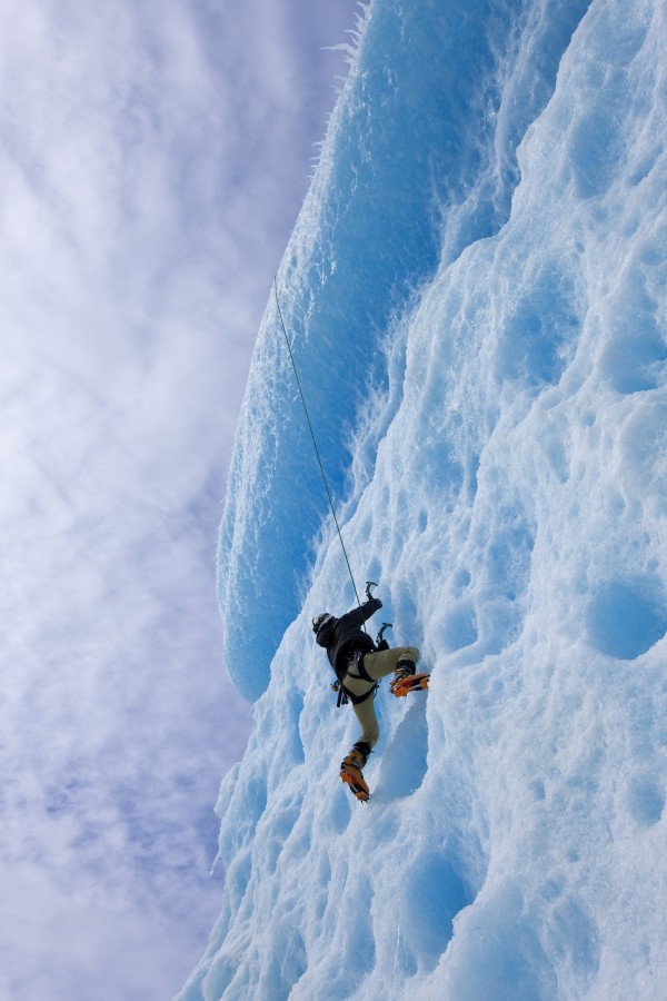 An Ice Climber Ascends The Face Of A Large Iceberg Frozen Into Mendenhall Lake, Juneau, Southeast Alaska, Winter by PacificStock
