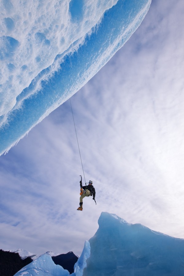 An Ice Climber Swings Down From Rope To Reach Face Of A Large Iceberg Frozen Into Mendenhall Lake, Juneau, Southeast Alaska, Winter by PacificStock