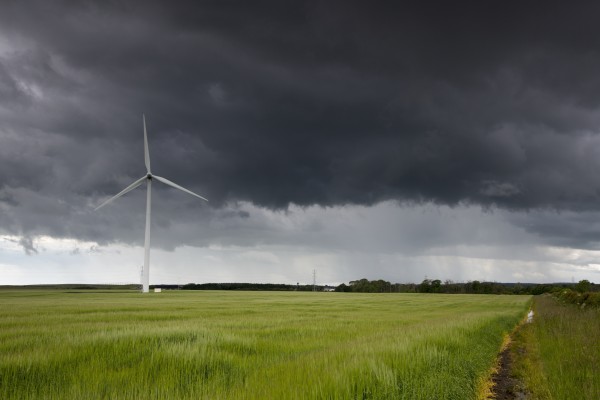 Wind turbine and storm clouds;Northumberland england by PacificStock