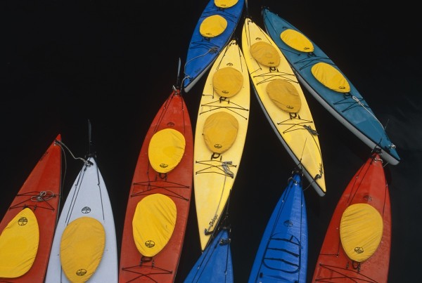 Abstract Overview Of Colorful Kayaks Tied Up Together On Water Inside Passage Southeast Alaska by PacificStock