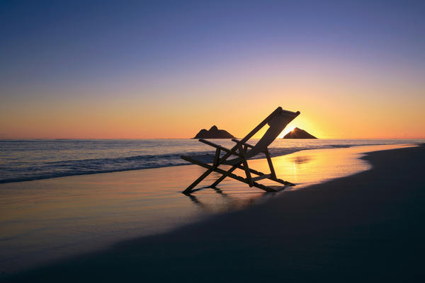 Hawaii, Lanikai, Empty beach chair at sunset. by PacificStock