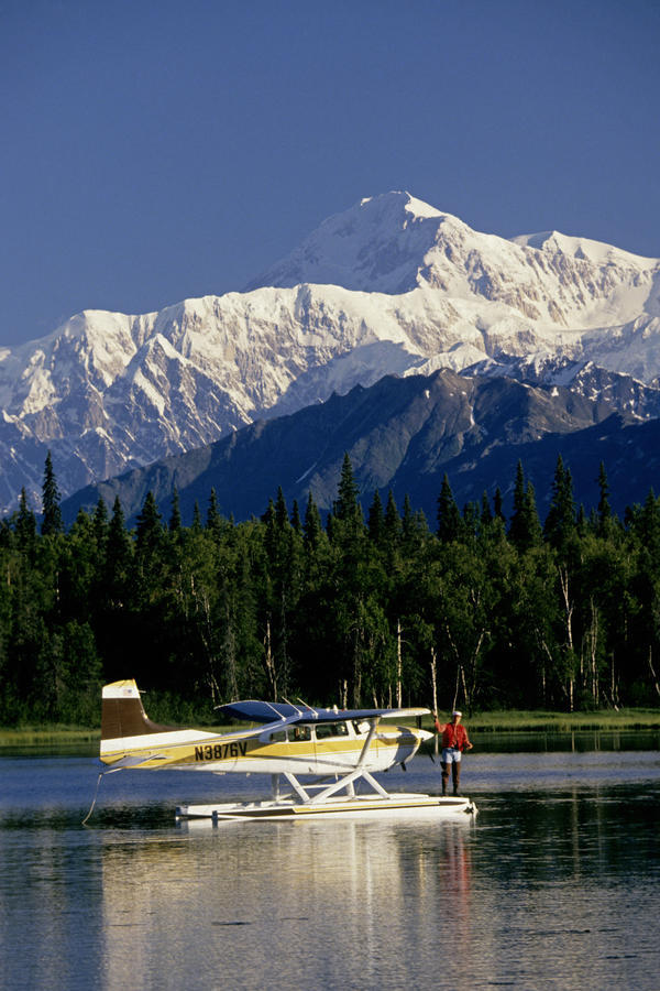Man Spin Fishing On Lake From Floatplane With Southside Mt. Mckinley And Alaska Range In The Background,Southcentral Alaska, Summer by PacificStock