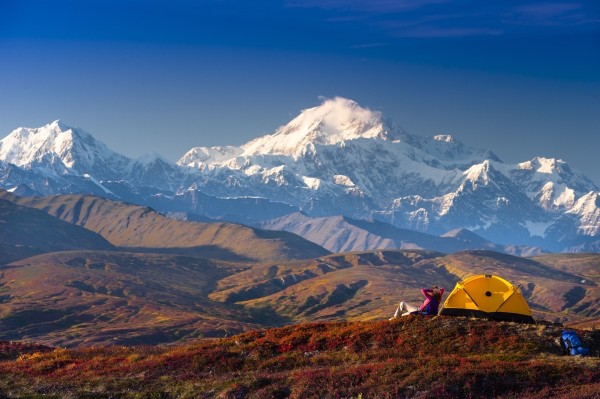 A Woman Relaxes Next To Her Tent In Peters Hills With A View Of Mt. Mckinley In The Background, Denali State Park, Southcentral Alaska, Fall by PacificStock