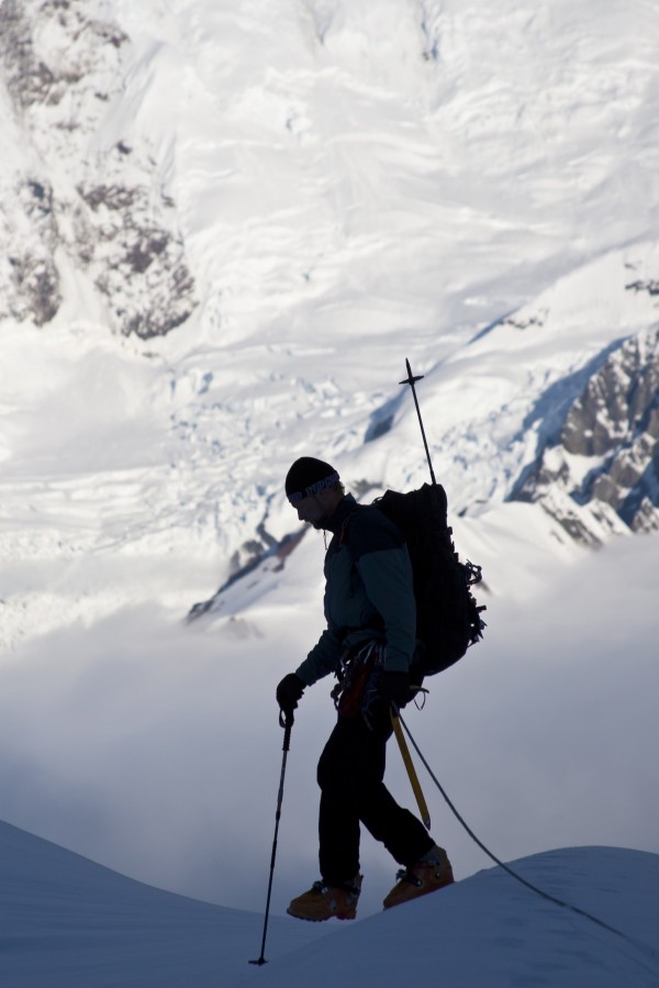 Climber Silhouetted On The Summit Of Control Tower With Glacier Icefall And Crevasses On Mount Foraker In The Background, Kahiltna Glacier, Alaska Range, Interior Alaska, Summer by PacificStock