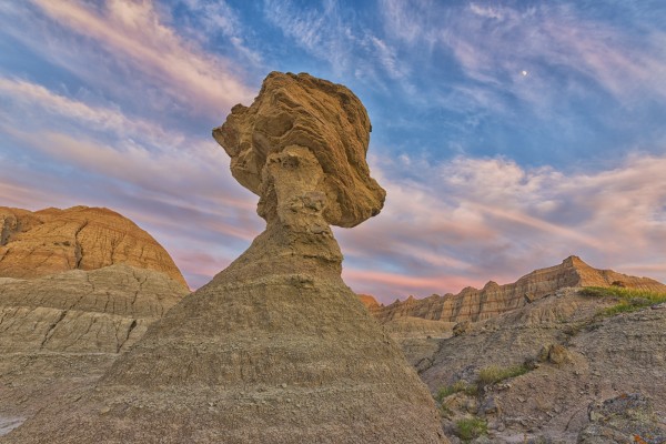 A large hoodoo balanced on a pedestal badlands national park; south dakota united states of america by PacificStock