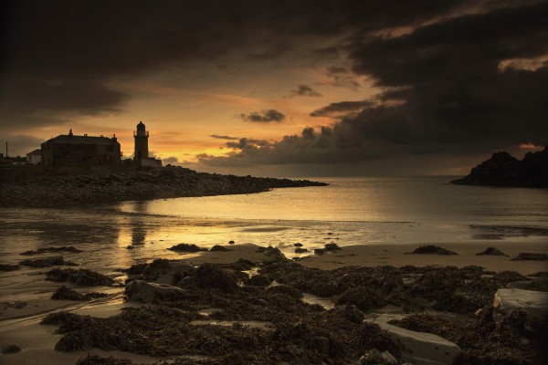 Silhouette of a lighthouse along the coast at sunset;Portpatrick dumfries and galloway scotland by PacificStock