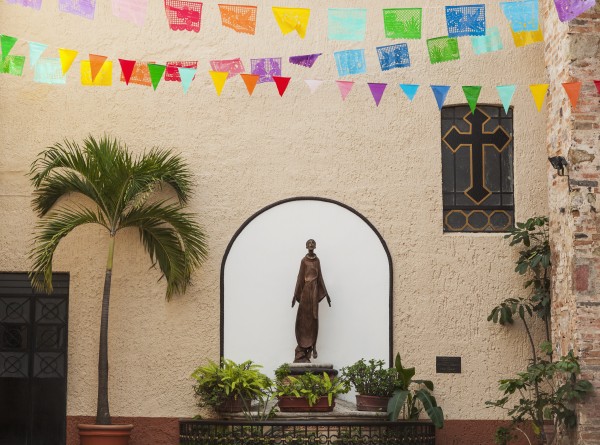 A sculpture of san francisco de assisi is sheltered by the church of our lady of guadalupe;Puerto vallarta mexico by PacificStock