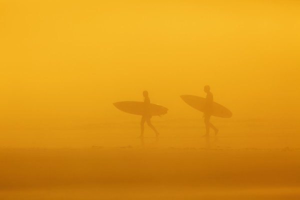 Surfers in the fog on long beach pacific rim national park;Vancouver island british columbia canada by PacificStock