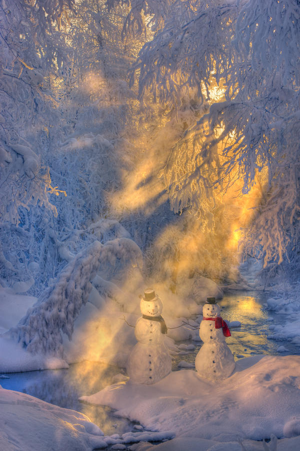 Snowman Couple Standing Next To A Stream With Sunrays Shining Through Fog And Hoar Frosted Trees In The Background, Russian Jack Springs Park, Anchorage, Southcentral Alaska, Winter. Digitally Enhanced. by PacificStock