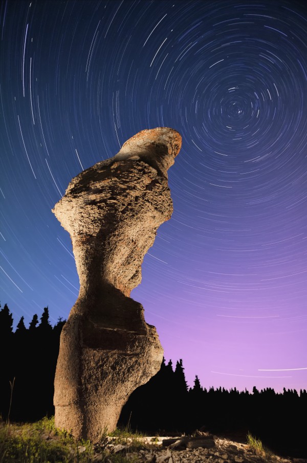 Light painting on monolith and star trails, Anse des Bonnes Femmes at Ile Niapiskau, Mingan Archipelago National Park Reserve of Canada, Cote-Nord, Duplessis region; Quebec, Canada Print