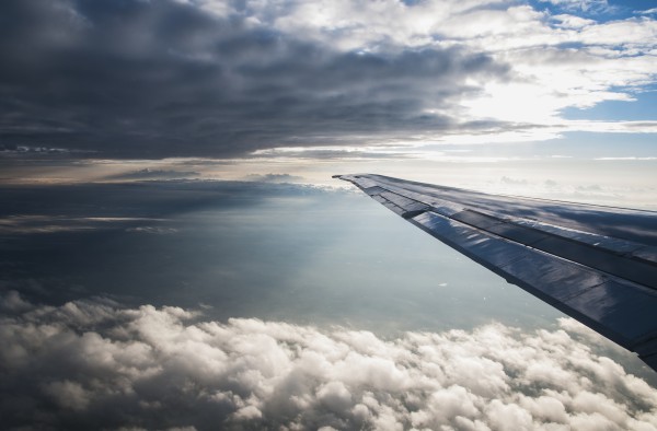 A commercial jet flies through the clouds; Colorado, United States of America by PacificStock