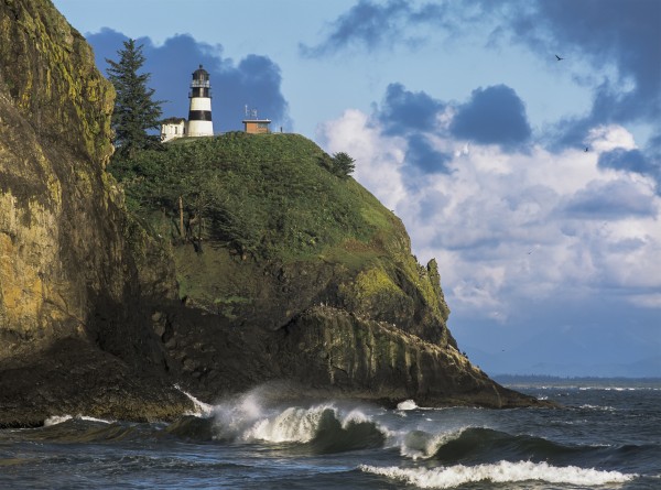 Waves break at Cape Disappointment Lighthouse; Ilwaco, Washington, United States of America by PacificStock