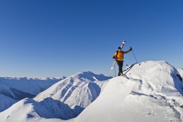 Man climbing a snow ridge for back country skiing, Turnagain Pass, Kenai Mountains, Southcentral Alaska, Winter by PacificStock