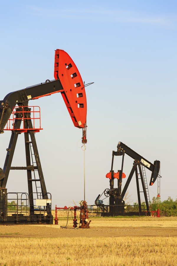 Oil well pump jacks at Bakken Oil Field near Estevan; Saskatchewan, Canada by PacificStock