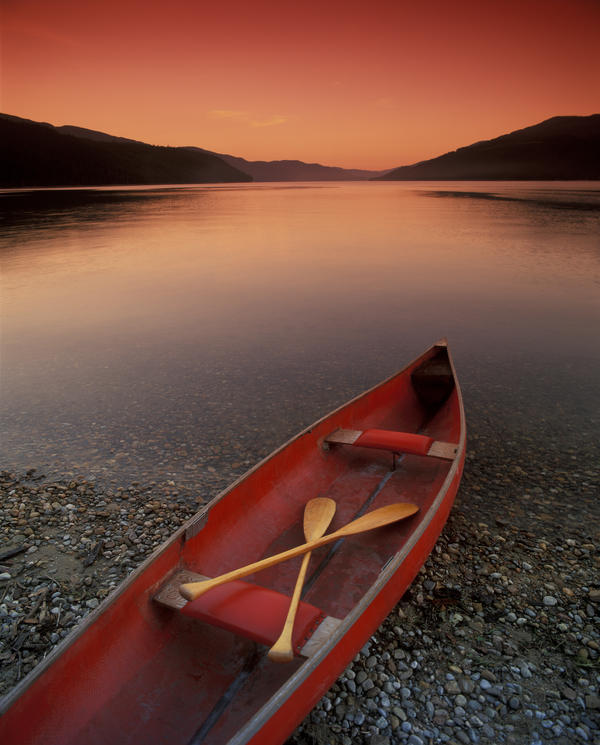 Canoe At Edge Of Mountain Lake, Shuswap, British Columbia, Canada by PacificStock