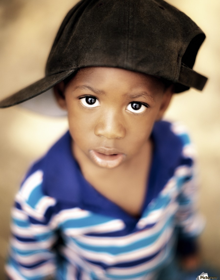 Boy Wearing Over Sized Hat Sideways by PacificStock Wall Art