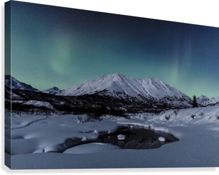 Aurora Borealis (Northern Lights) dance above Idaho Peak and the Little Susitna River at Hatcher Pass in winter, South-central Alaska; Alaska, United States of America  Canvas Print