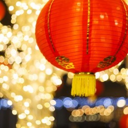Red and gold Chinese lantern with sparkling white lights in the background, Granville Island; Vancouver, British Columbia, Canada