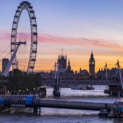 Millennium Wheel and skyline at sunset; London, England