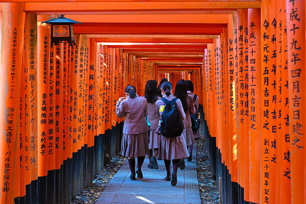 Path of Prayers - Students Walking Through Torii Gates in Kyoto by Matthias Hauser
