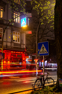 Long exposure night shot of a colourfully lit up street in Hamburg Altona