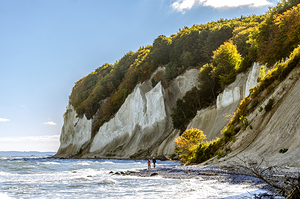 People hiking in front of the famous white chalk cliffs on the island of Rügen in Germany