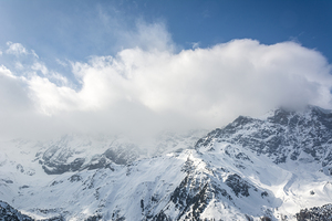Clouds over mountain range in the European Alps in winter 