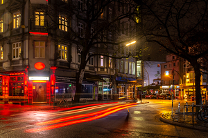Long exposure night shot of a colourfully lit up streetcorner in Hamburg Altona
