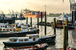 Historic boats in the old museum harbor in Hamburg Övelgönne at the Elbe River at sunrise 
