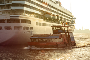 Ferry on the Elbe River in the harbor district in Hamburg during golden sunset 
