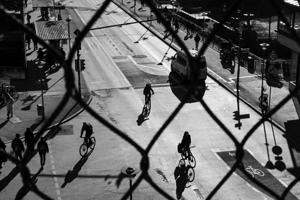 Black and white capture of bicycles on a road in the city 