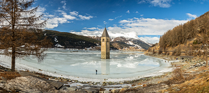 Panorama shot of flooded church tower in Lake Reschen Reschensee in South Tyrol Italy