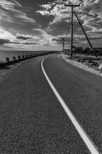 Black and white shot of coastal road on Cape Cod in New England 