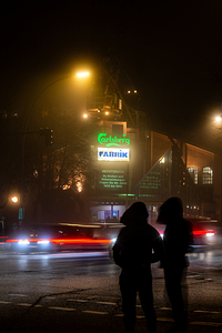 Long exposure night shot of street corner and people in Hamburg Altona