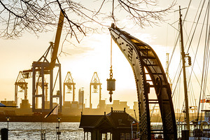 Historic crane at the old harbor in Hamburg Övelgönne at the Elbe River at sunset