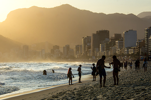 People enjoying a beautiful sunset at Ipanema Beach in Rio de Janeiro 